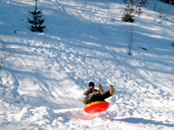 Een blik op een man die glijd op de sneeuw met een band